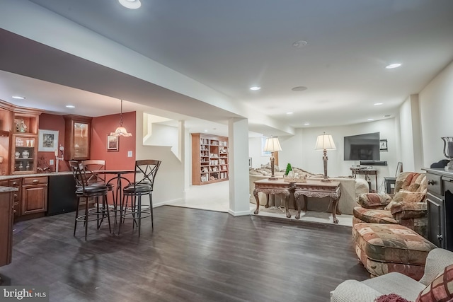 dining room with a fireplace and dark hardwood / wood-style flooring