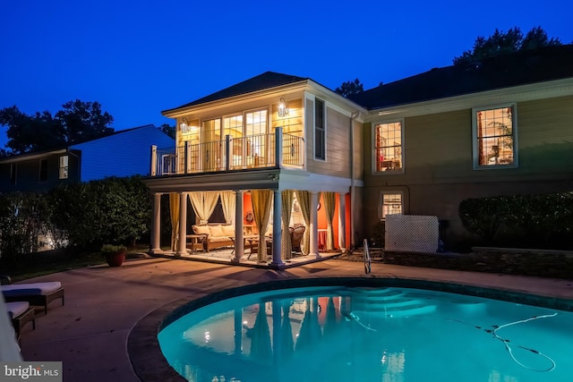 view of swimming pool with outdoor lounge area and a patio