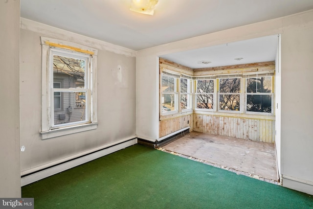 interior space with a baseboard heating unit and a wealth of natural light