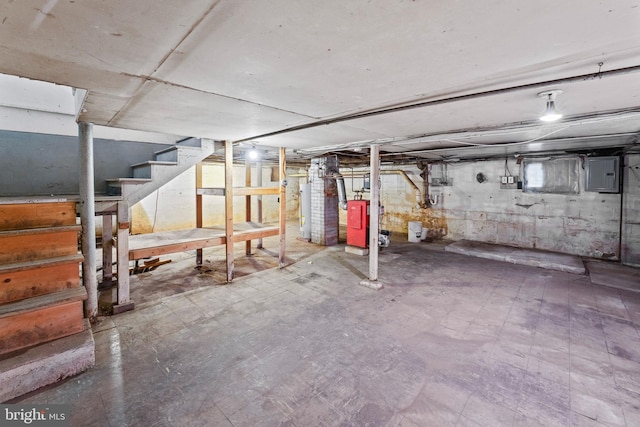 basement with electric panel and water heater