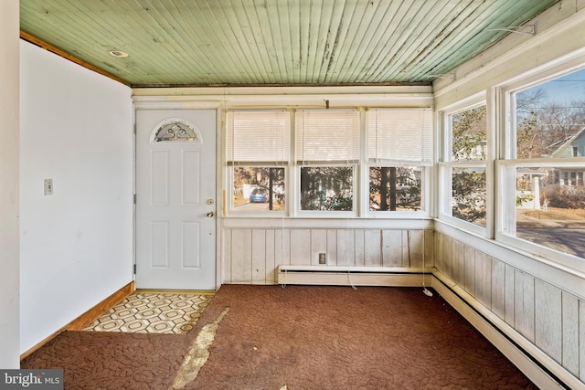 unfurnished sunroom with a baseboard heating unit and wooden ceiling