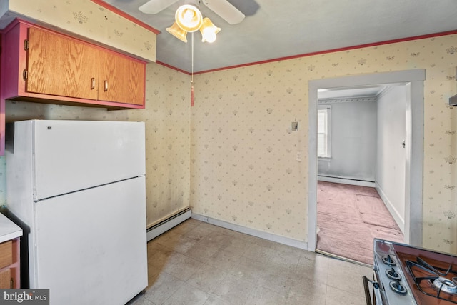 kitchen with ceiling fan, crown molding, baseboard heating, and white refrigerator