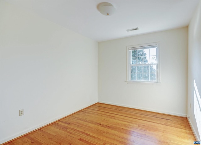 spare room featuring light wood-type flooring