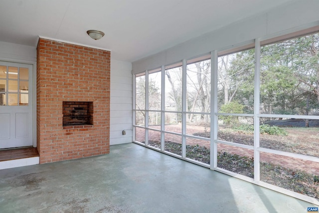 unfurnished sunroom featuring a fireplace