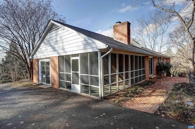 view of side of home with a sunroom