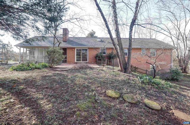 back of house featuring a sunroom