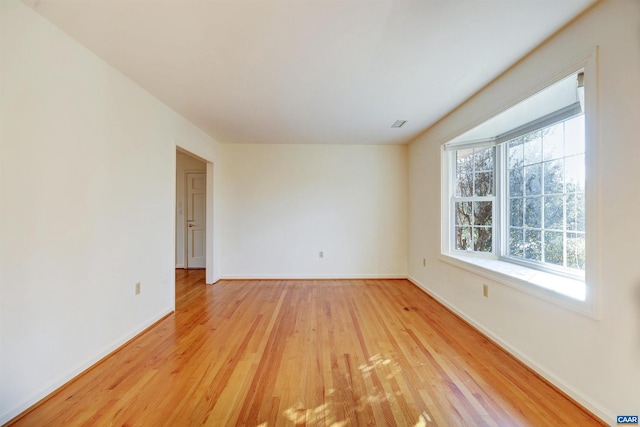 spare room featuring light hardwood / wood-style floors