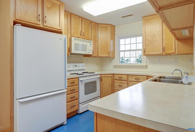 kitchen featuring sink, white appliances, and light brown cabinets