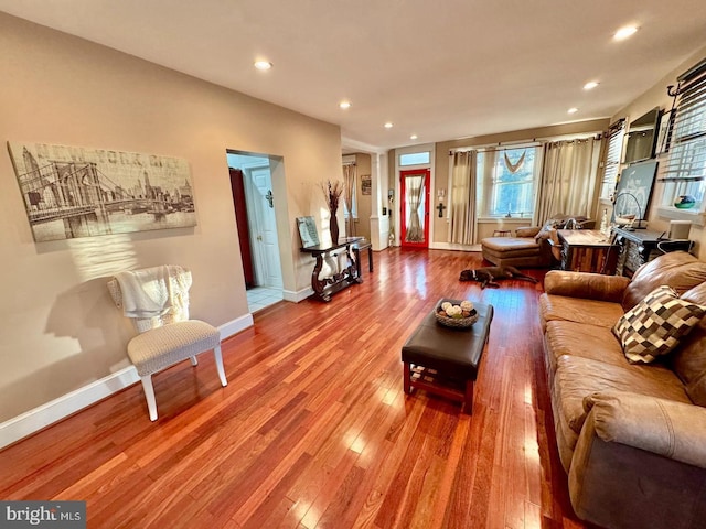 living room with hardwood / wood-style flooring and decorative columns