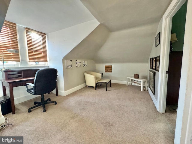 carpeted office featuring lofted ceiling