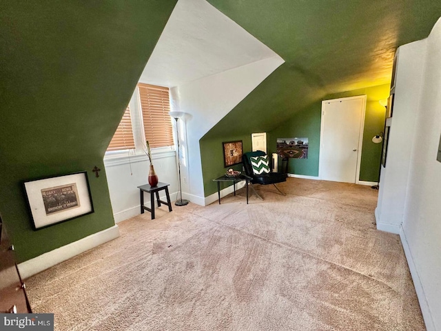 additional living space featuring light colored carpet and lofted ceiling