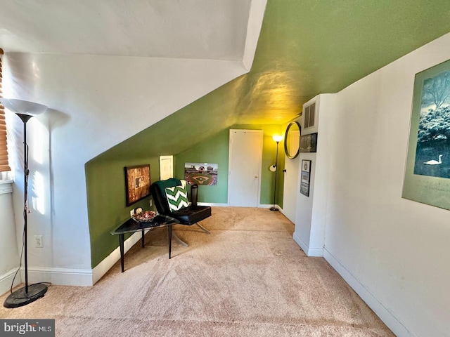 interior space with light colored carpet and vaulted ceiling