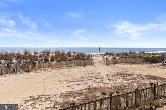 exterior space featuring a water view and a view of the beach