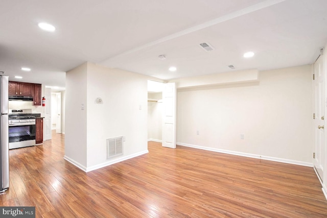 empty room with light hardwood / wood-style flooring