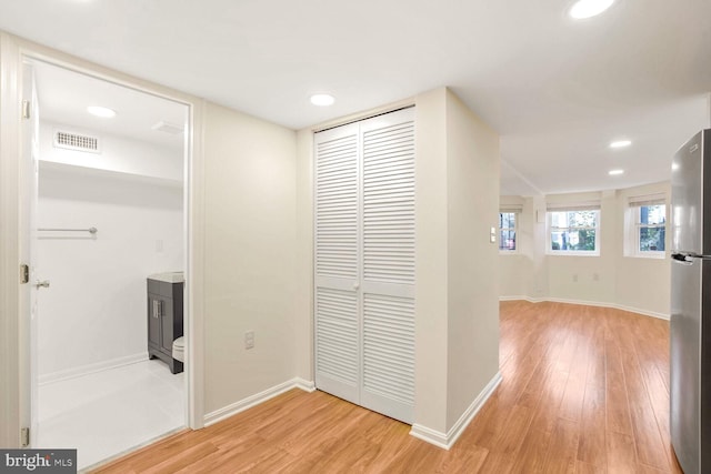 hallway with light hardwood / wood-style flooring