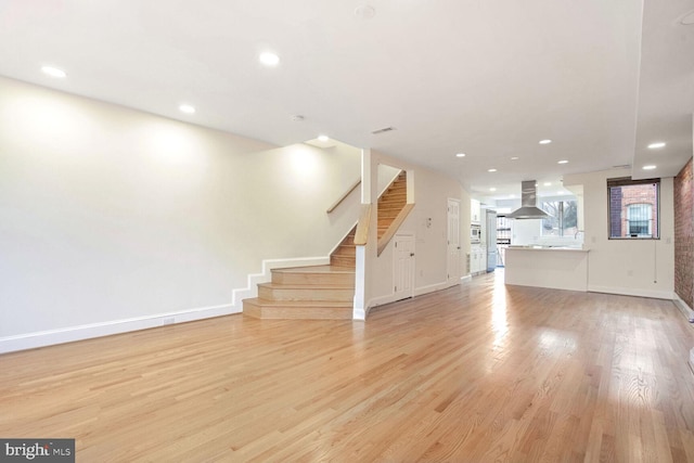 unfurnished living room featuring light wood-type flooring