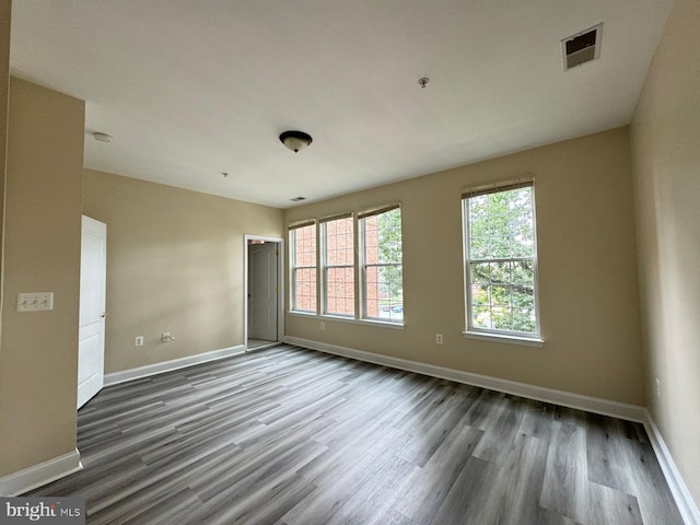 spare room featuring dark hardwood / wood-style floors