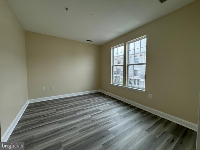 spare room with hardwood / wood-style floors