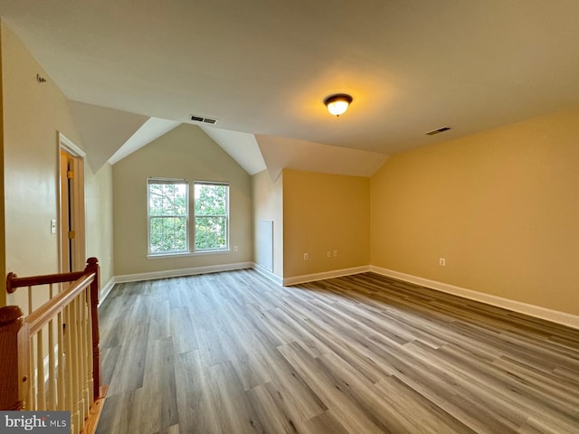 bonus room featuring hardwood / wood-style floors and lofted ceiling