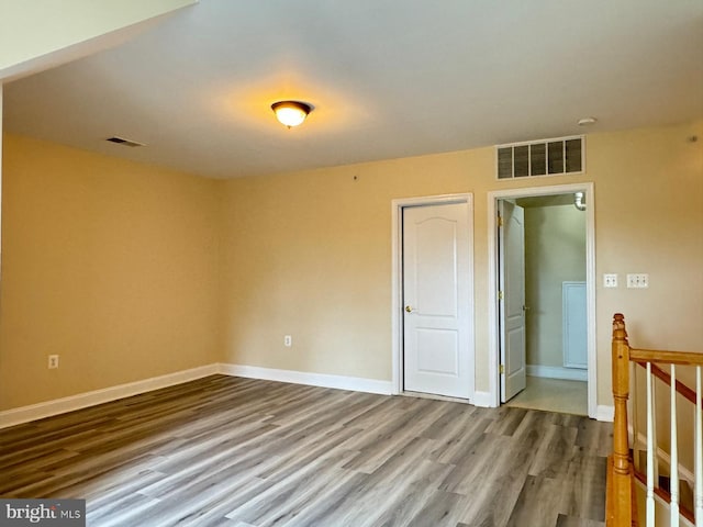 unfurnished room with hardwood / wood-style floors