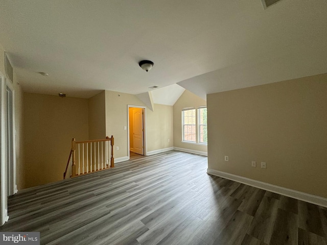 bonus room with vaulted ceiling and hardwood / wood-style flooring