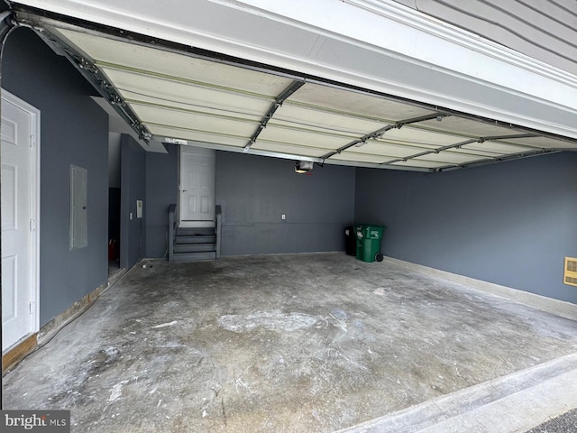 garage with electric panel and a garage door opener