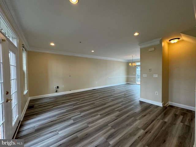 unfurnished room with french doors, a chandelier, dark hardwood / wood-style floors, and ornamental molding