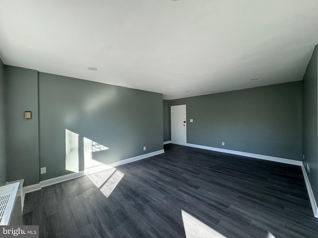 unfurnished room featuring dark hardwood / wood-style floors