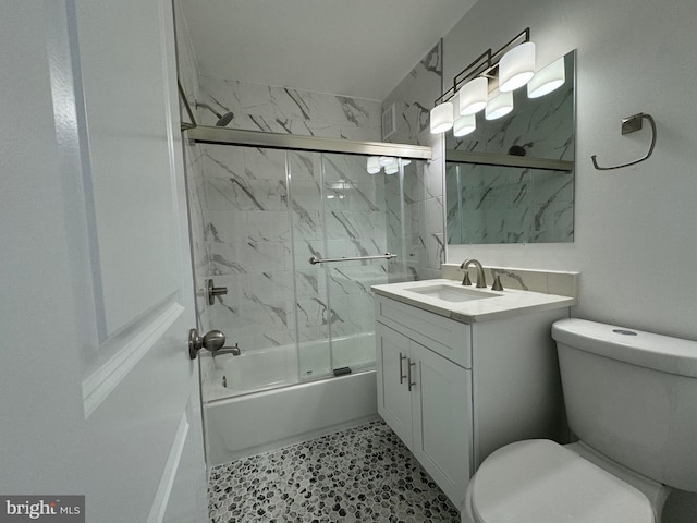 full bathroom with shower / bath combination with glass door, vanity, and toilet