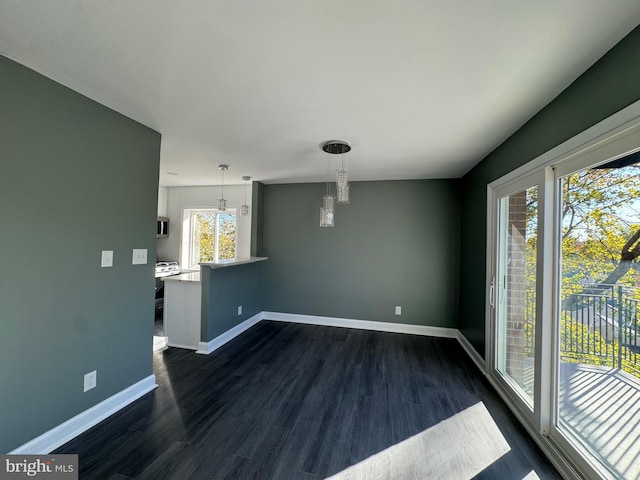 interior space with dark wood-type flooring and an inviting chandelier