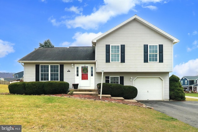 split level home with a garage and a front lawn