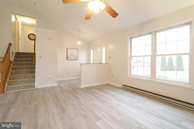 unfurnished living room with ceiling fan, a baseboard heating unit, light hardwood / wood-style flooring, and vaulted ceiling