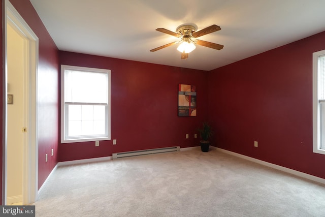 carpeted empty room with a baseboard radiator and ceiling fan