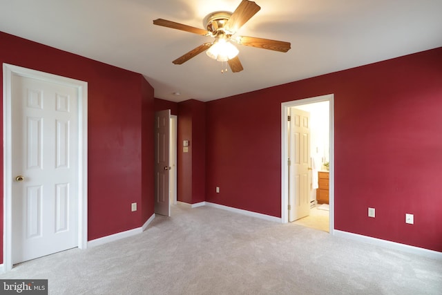 unfurnished bedroom with ensuite bathroom, ceiling fan, and light colored carpet