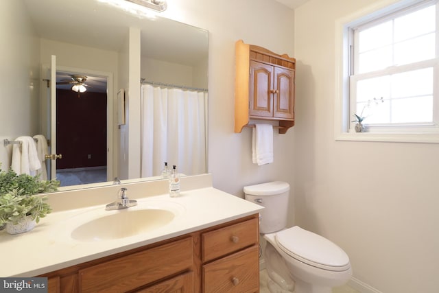 bathroom featuring ceiling fan, vanity, and toilet