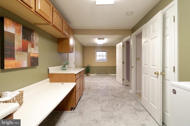 bathroom with baseboard heating and washer / clothes dryer