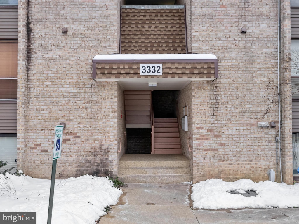 view of snow covered property entrance