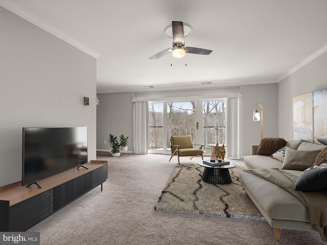 carpeted living room with ceiling fan and crown molding