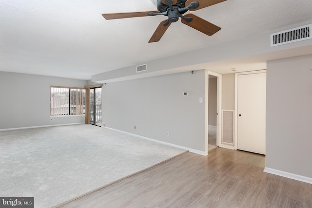 empty room featuring ceiling fan and light hardwood / wood-style flooring