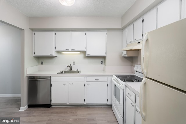 kitchen with white appliances, white cabinets, a textured ceiling, and sink