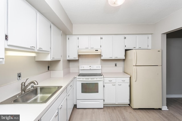 kitchen with white appliances, a textured ceiling, white cabinetry, and sink