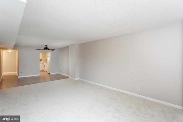 unfurnished living room with ceiling fan and light carpet