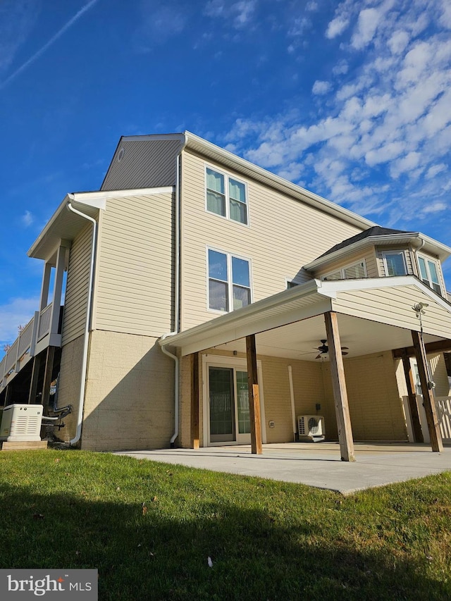 rear view of property with ac unit, a lawn, a patio, and ceiling fan