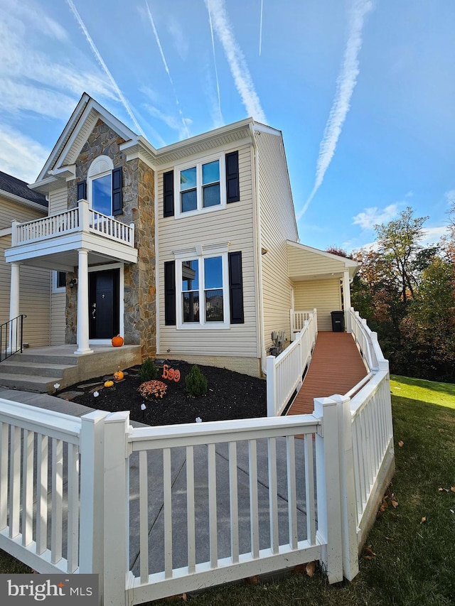 exterior space with a balcony and covered porch