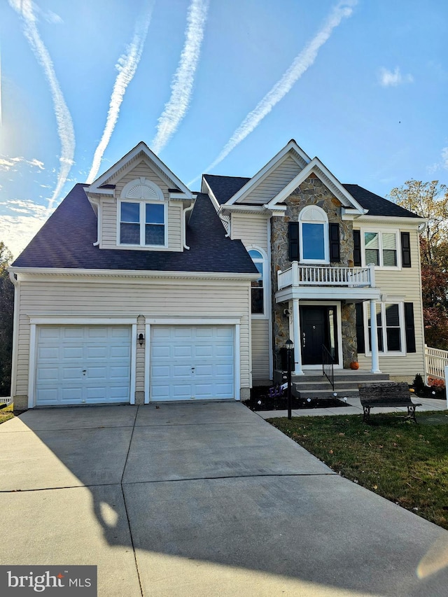 view of front of house with a garage and a balcony