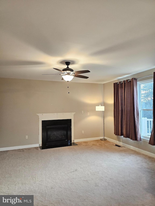 unfurnished living room with light carpet and ceiling fan