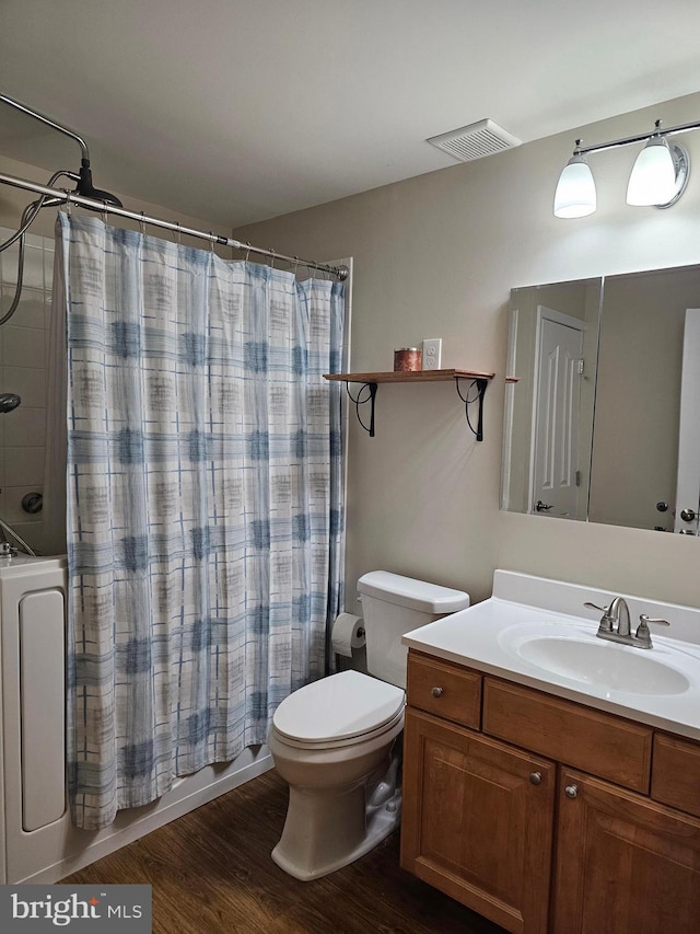 full bathroom featuring vanity, hardwood / wood-style floors, toilet, and shower / bath combo with shower curtain