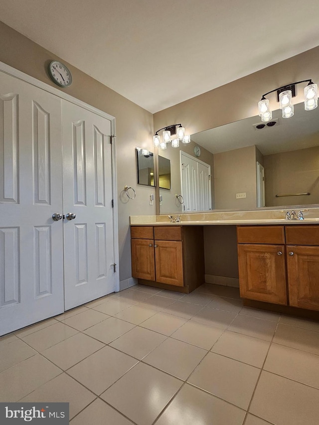 bathroom featuring tile patterned flooring and vanity