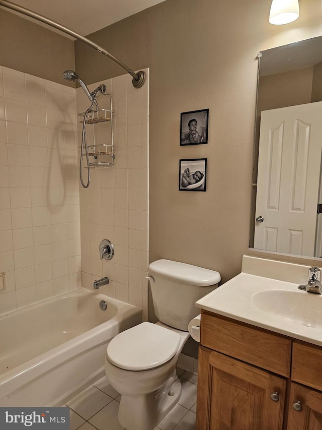 full bathroom featuring vanity, tiled shower / bath, tile patterned floors, and toilet