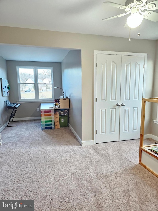 carpeted bedroom with ceiling fan and a closet